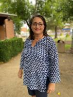 A woman standing in front of a building.