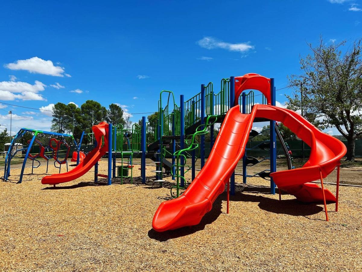 Colorful playground featuring red and blue slides