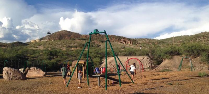Children and adults play together on a colorful playground