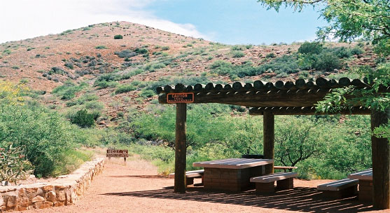 A picnic table on a dirt path.