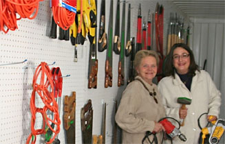 two women standing in a tool shed
