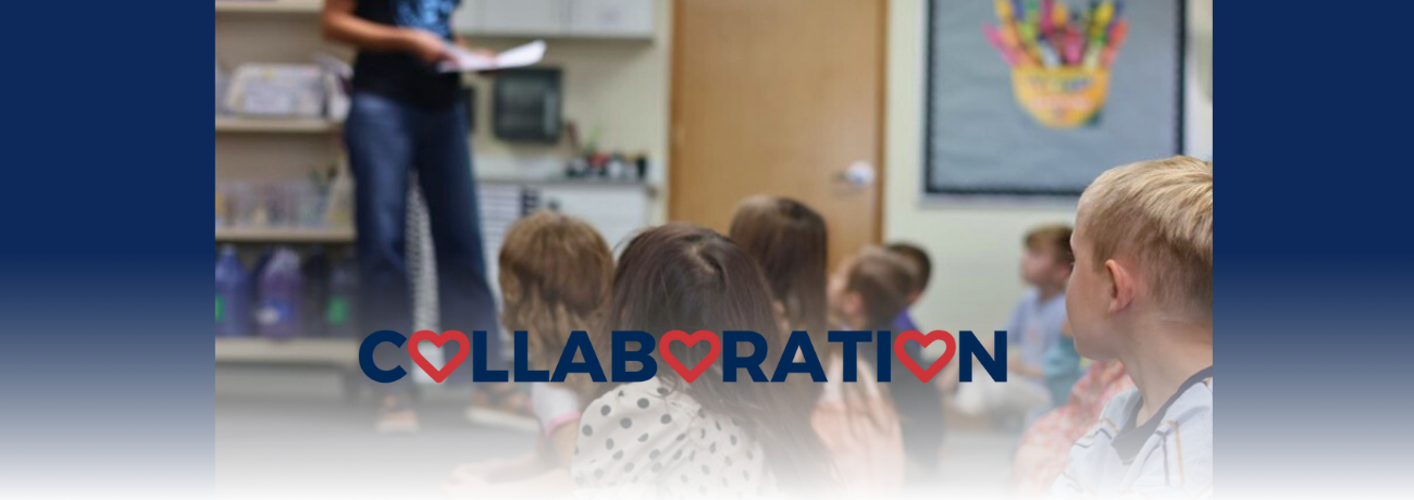 Educator stands before students in HHES classroom.