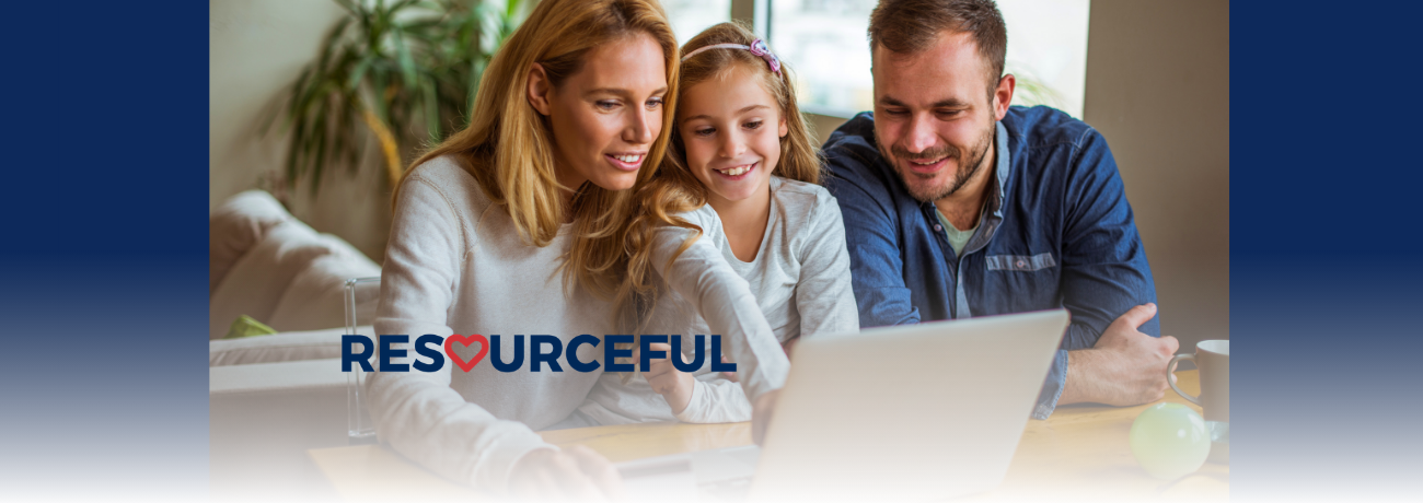 Stock photo of parents with their child looking at a laptop.