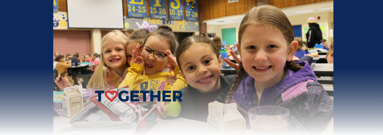 Kindergarten students together at the lunch table.