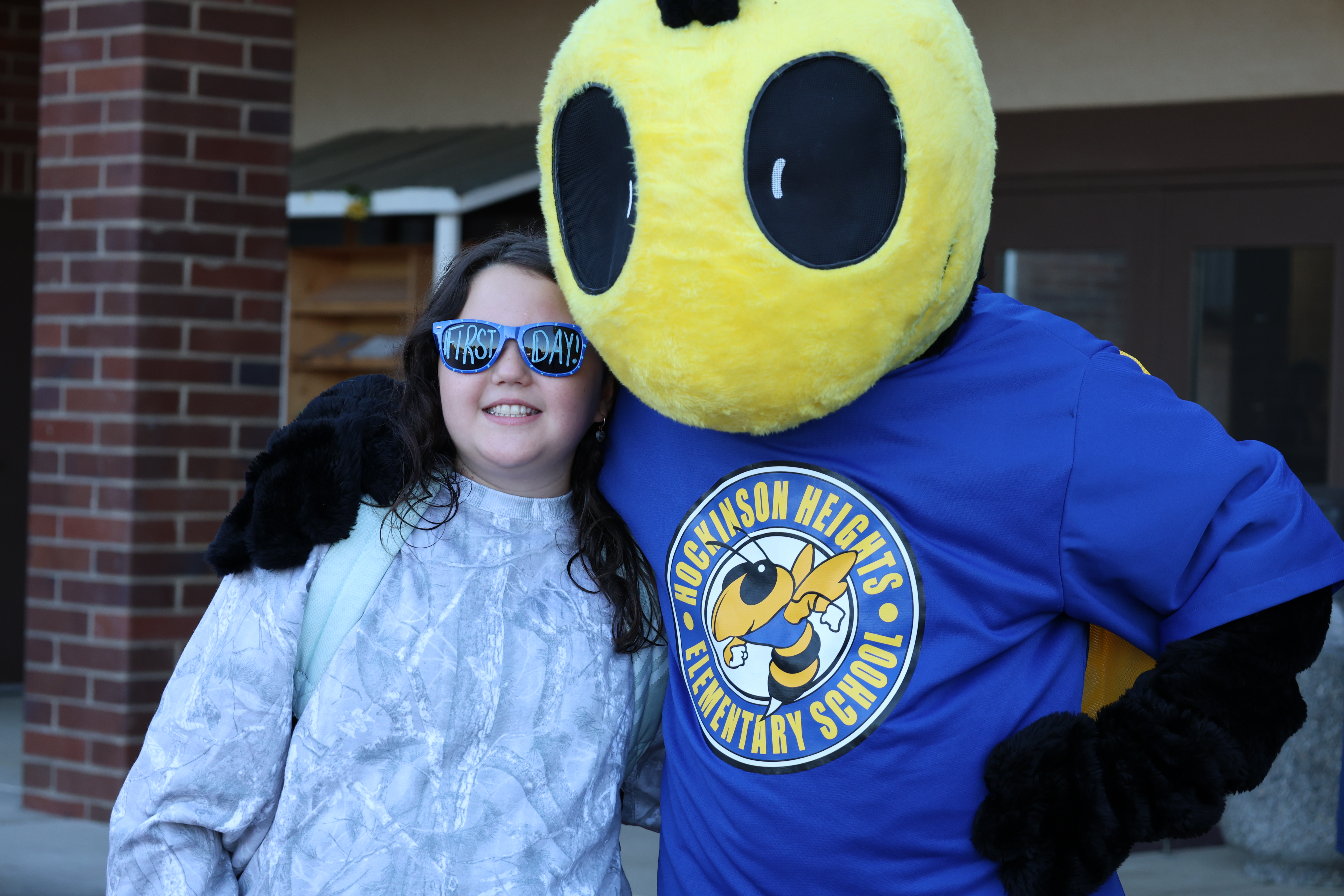 Photo of HHES student and Buzz mascot