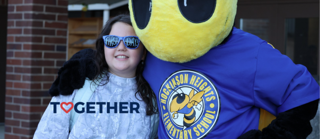 Photo of HHES student and Buzz mascot