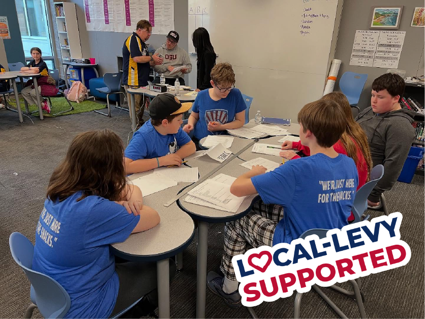 Students at Knowledge Bowl competing around table