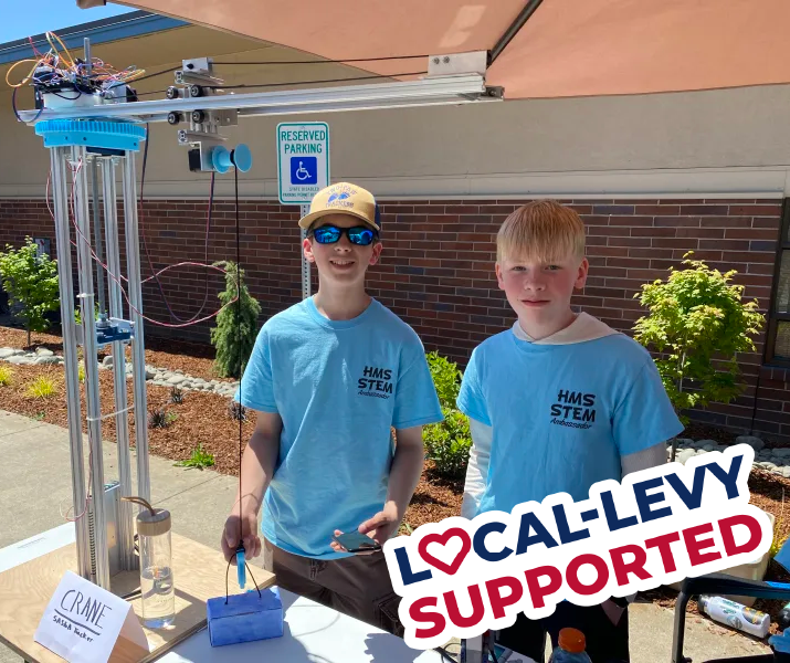 Boys at outdoor table wearing STEM shirts