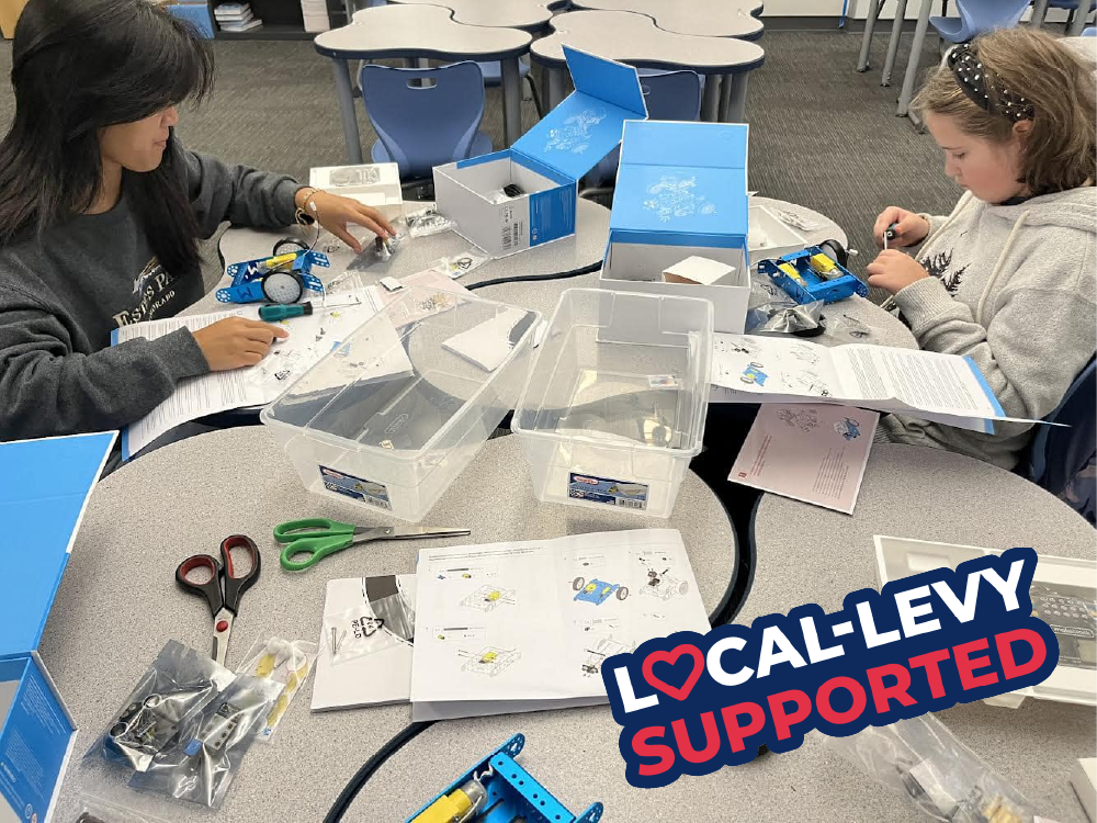 Girls STEM club participants build robots