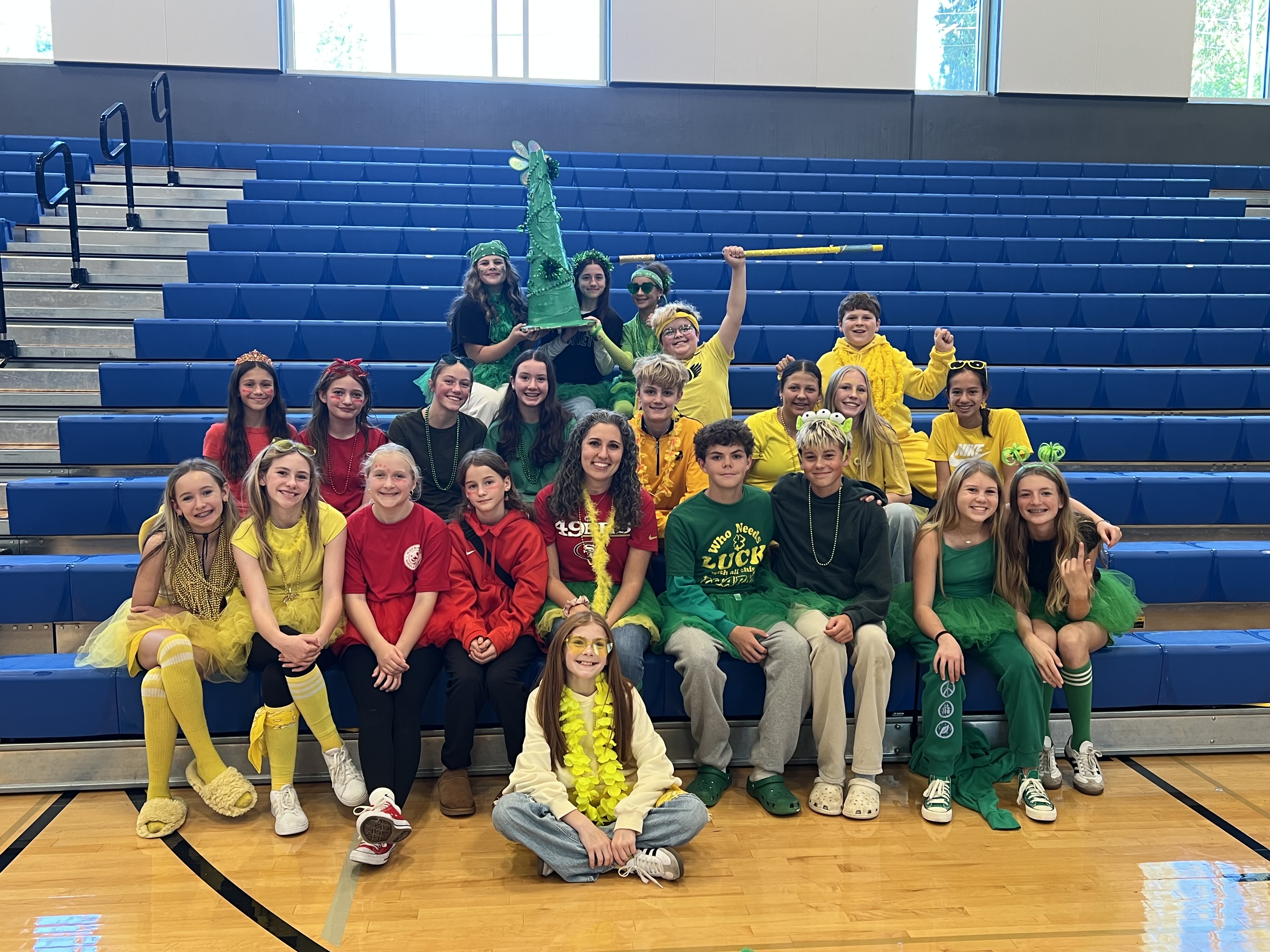 Group of students in indoor gym wearing bright colors.