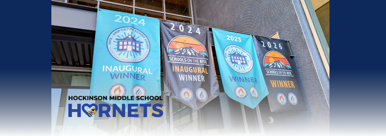 HMS flags hanging outside school entrance.