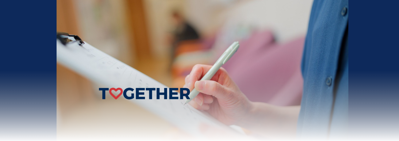 Stock image of person's hand writing on a clipboard.