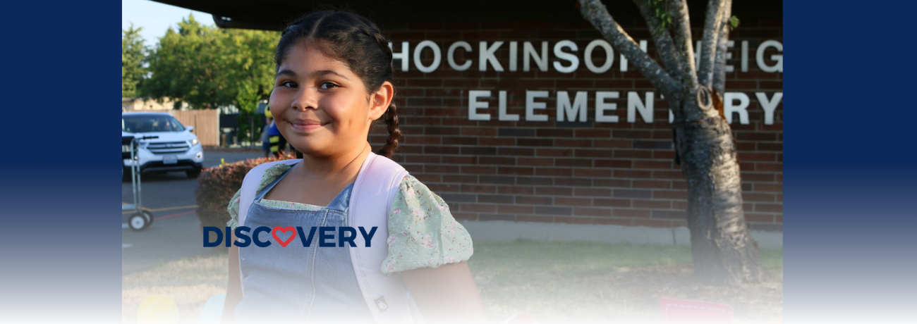 HHES student standing in front of the school.