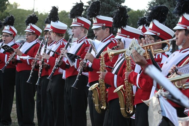 A group of men in red and white uniforms playing musical instruments