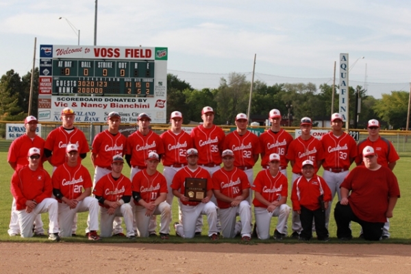 A baseball team posing for a picture on the field