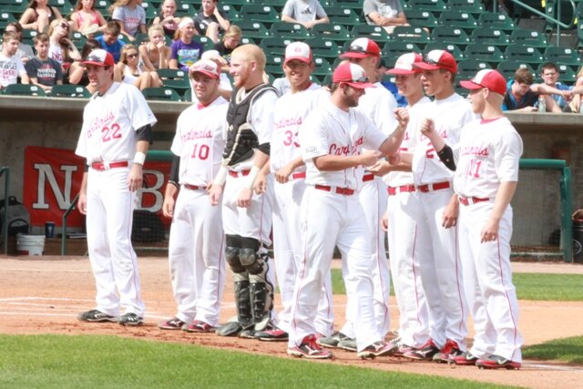 A group of men standing on top of a baseball field