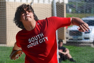 Competitor throws discus at boys track and field meet in South City, Michigan.