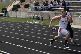 A dynamic scene of three runners competing in a 400-meter relay, emphasizing speed and collaboration in athletics.