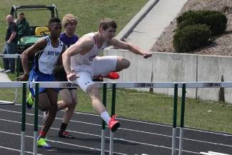 Two boys competing in high jump at state track meet in Chicago.