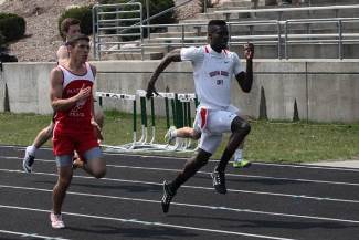 Two boys competing in high jump at state track meet in Chicago.