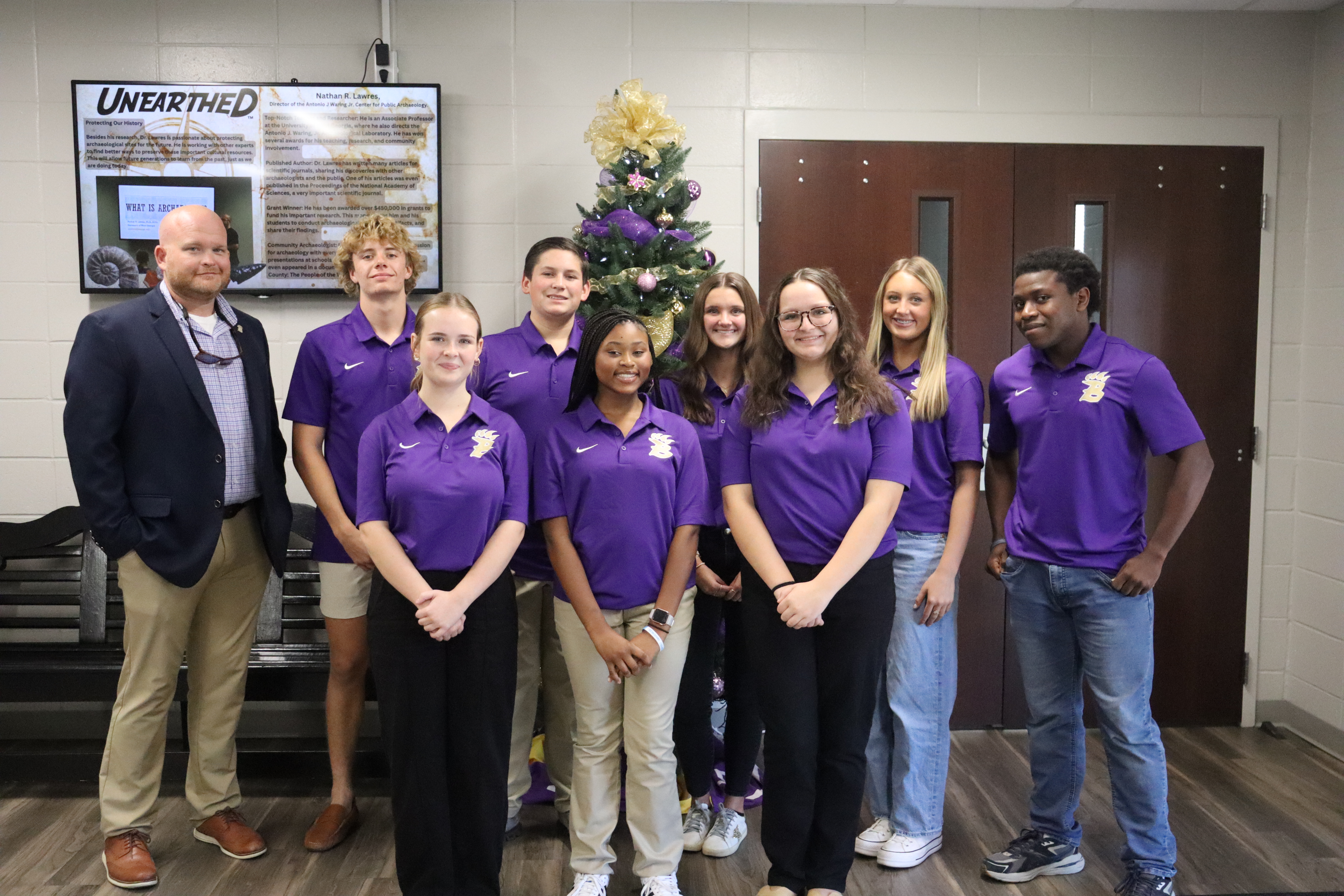 bearcat ambassadors stand in front of the board of education