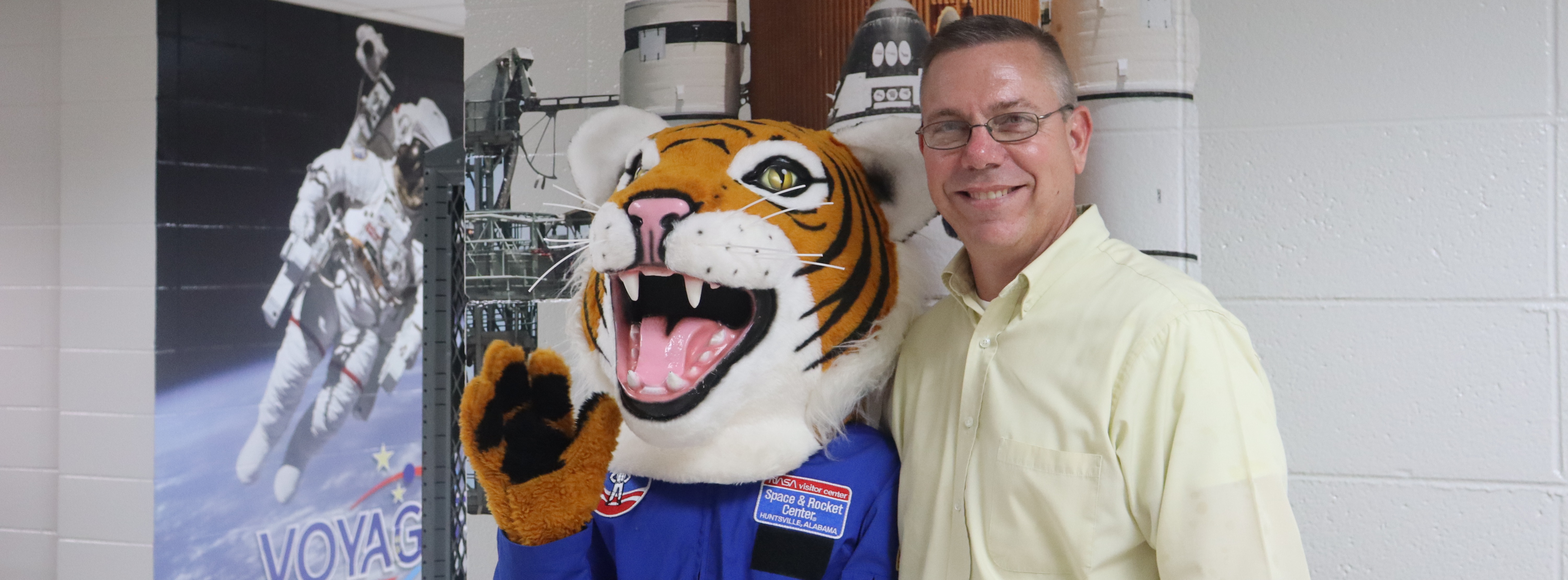 hutto tiger poses with prinicpal morehouse in space suit