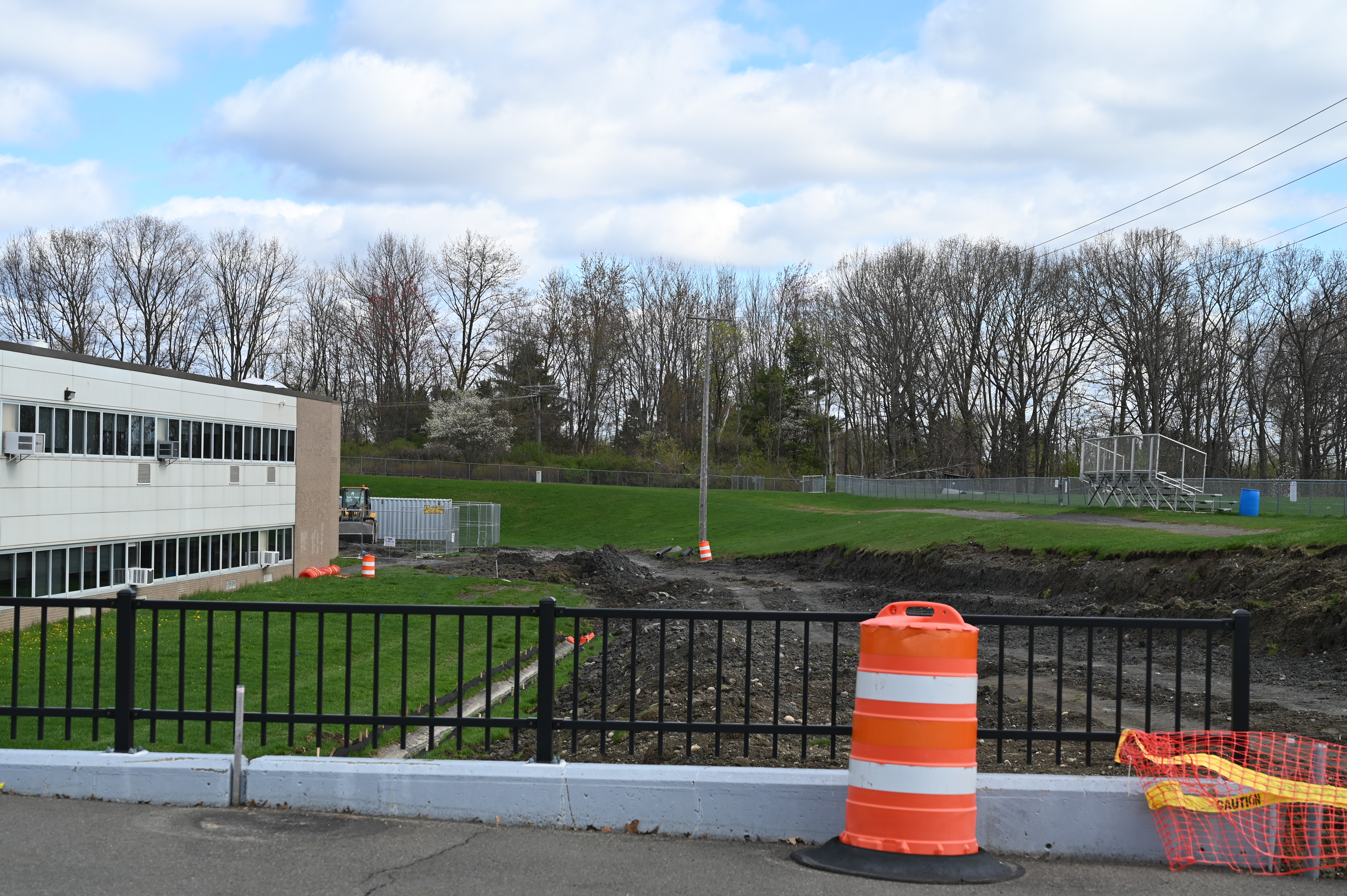 A path leads along the high school and back behind J-wing where construction begins to take place.