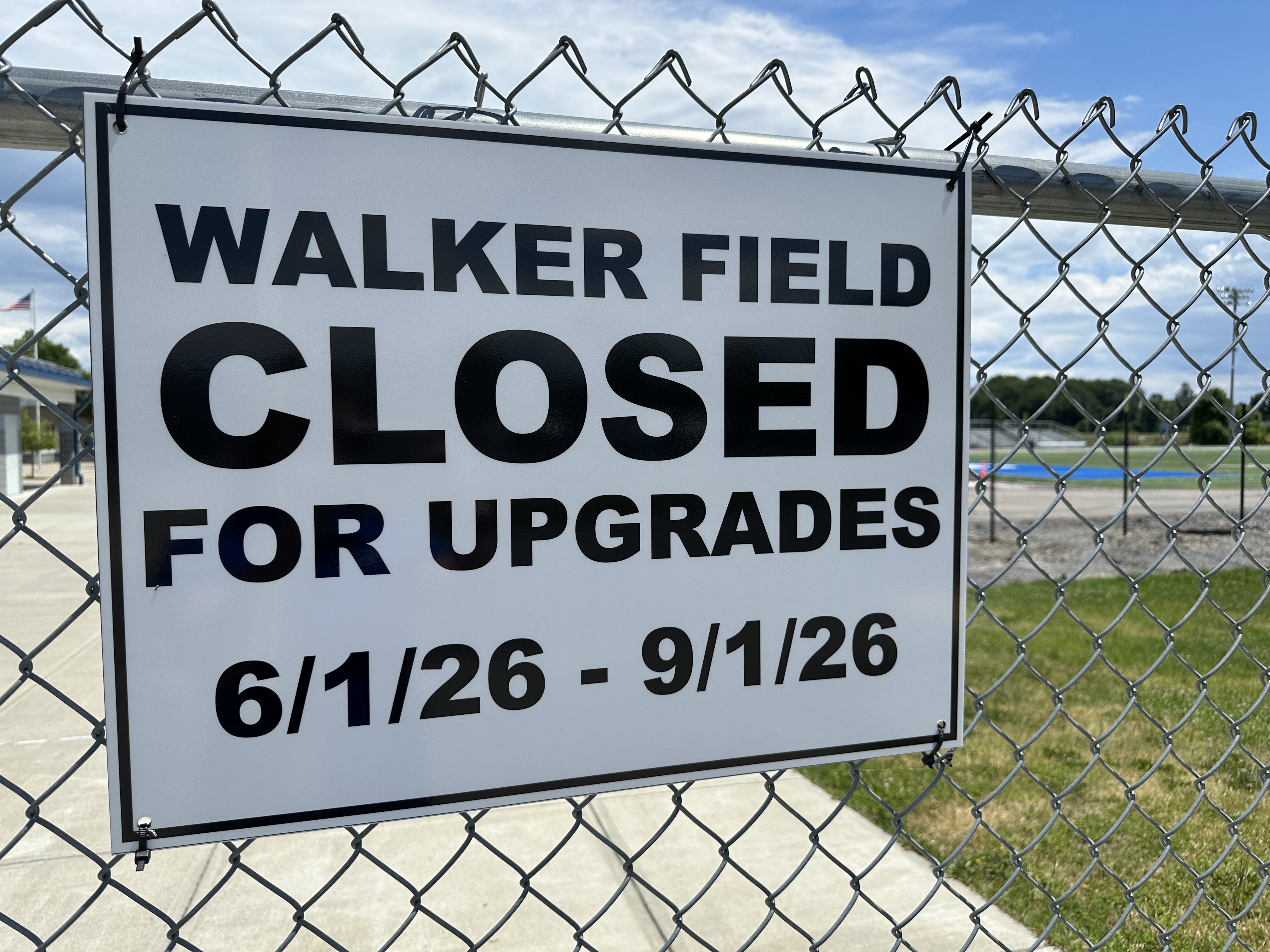A sign on a fence that reads "Walker Field Closed for Upgrades 6/1/26-9/1/26"
