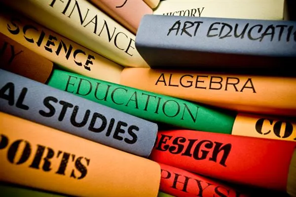 A stack of books labeled with the words education, science, and art, symbolizing knowledge and learning.