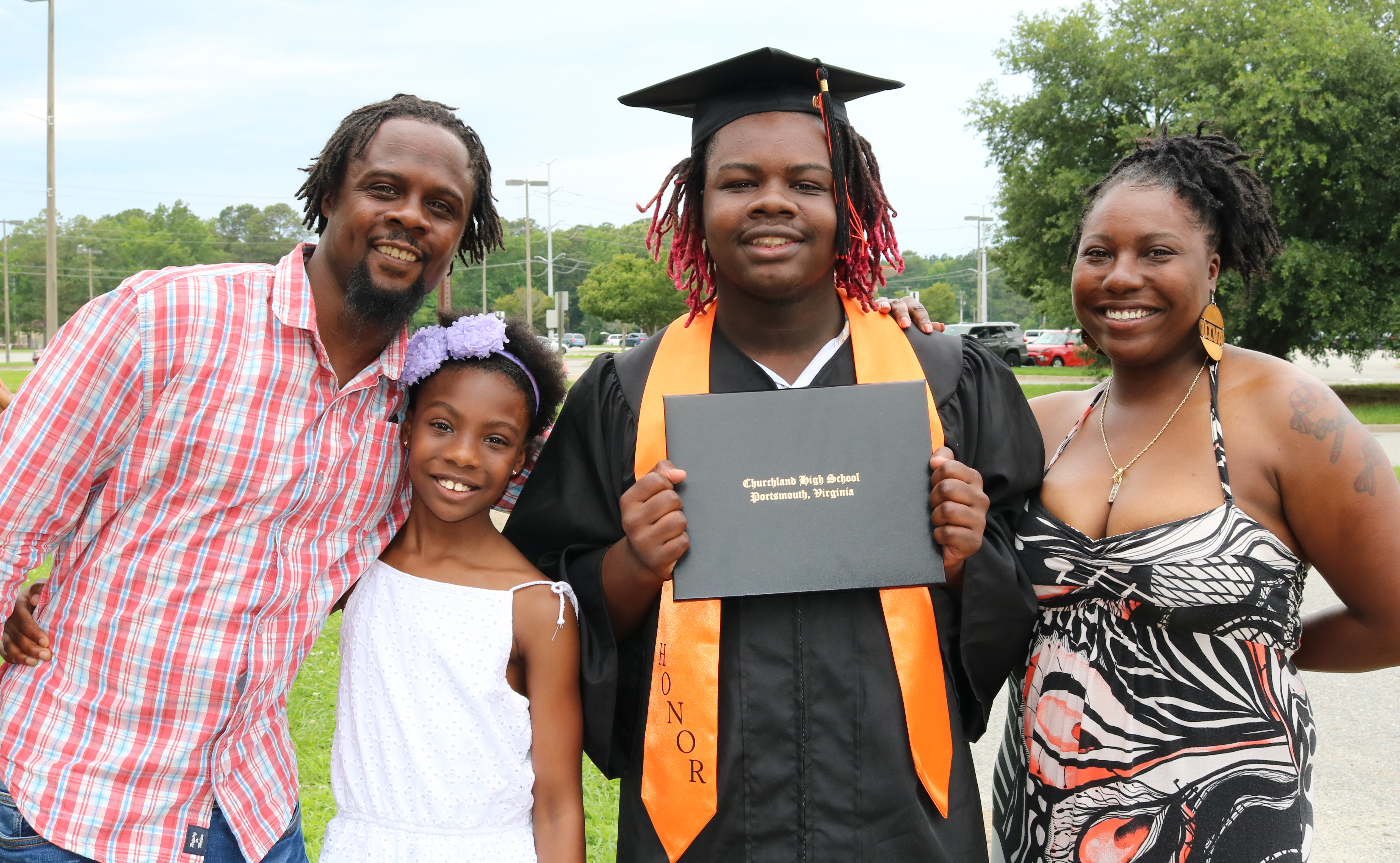 Family graduatee smiling looking at camera