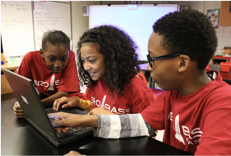 students with laptop in clasroom