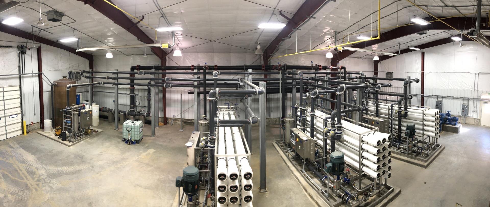 A spacious room filled with various pipes running along the walls and ceiling