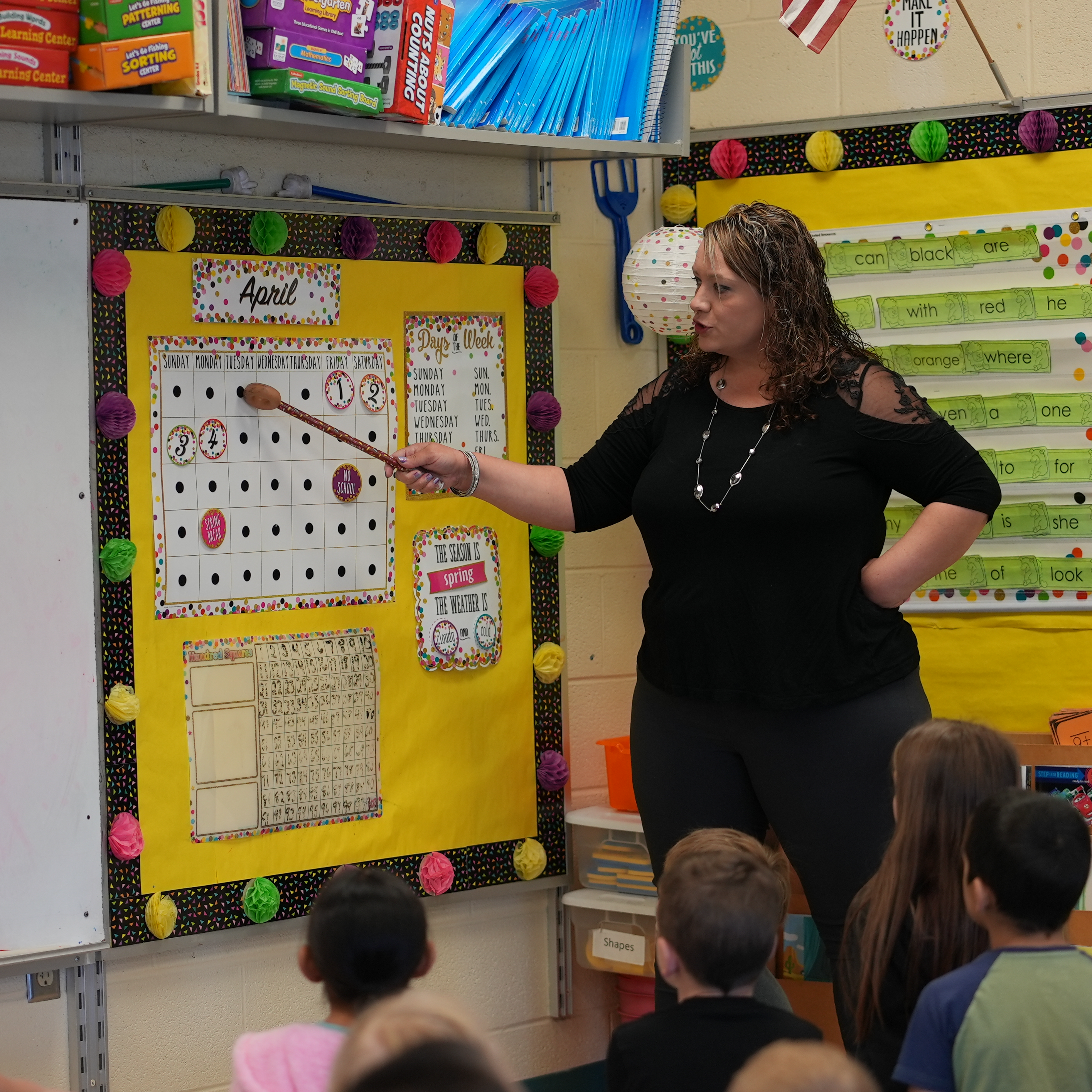 Teacher talking about a calendar with students