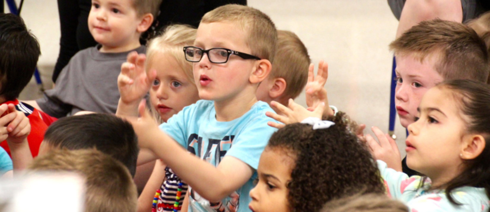 photo of students doing hand motions