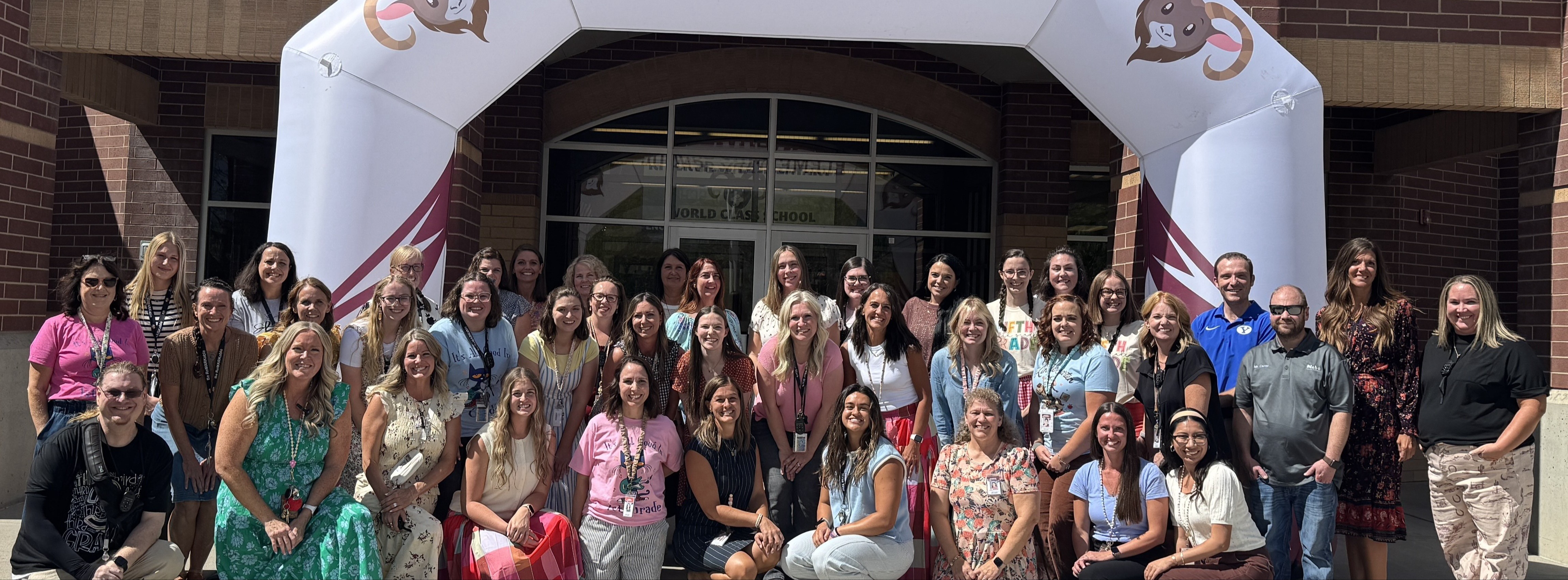 Faculty group picture outside in front of the building on the first day of school.