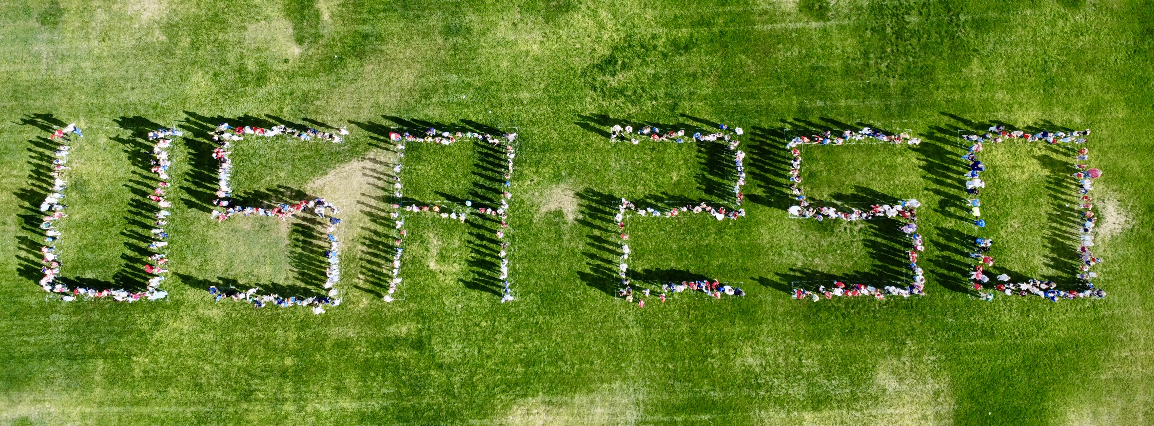 students spell out USA on the field