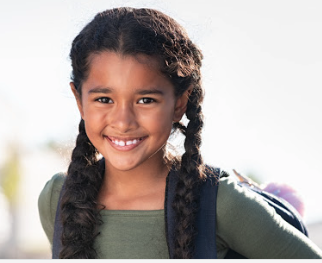 girl with a backpack and smiling