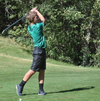 a boy golfing