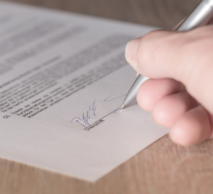 person signing a paper