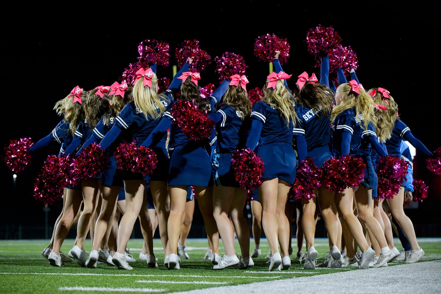 Cheerleaders with pink poms