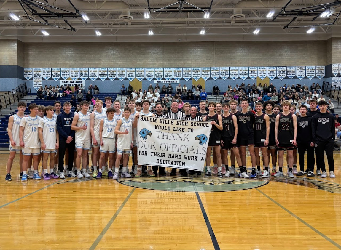 Basketball team with official's thank you banner