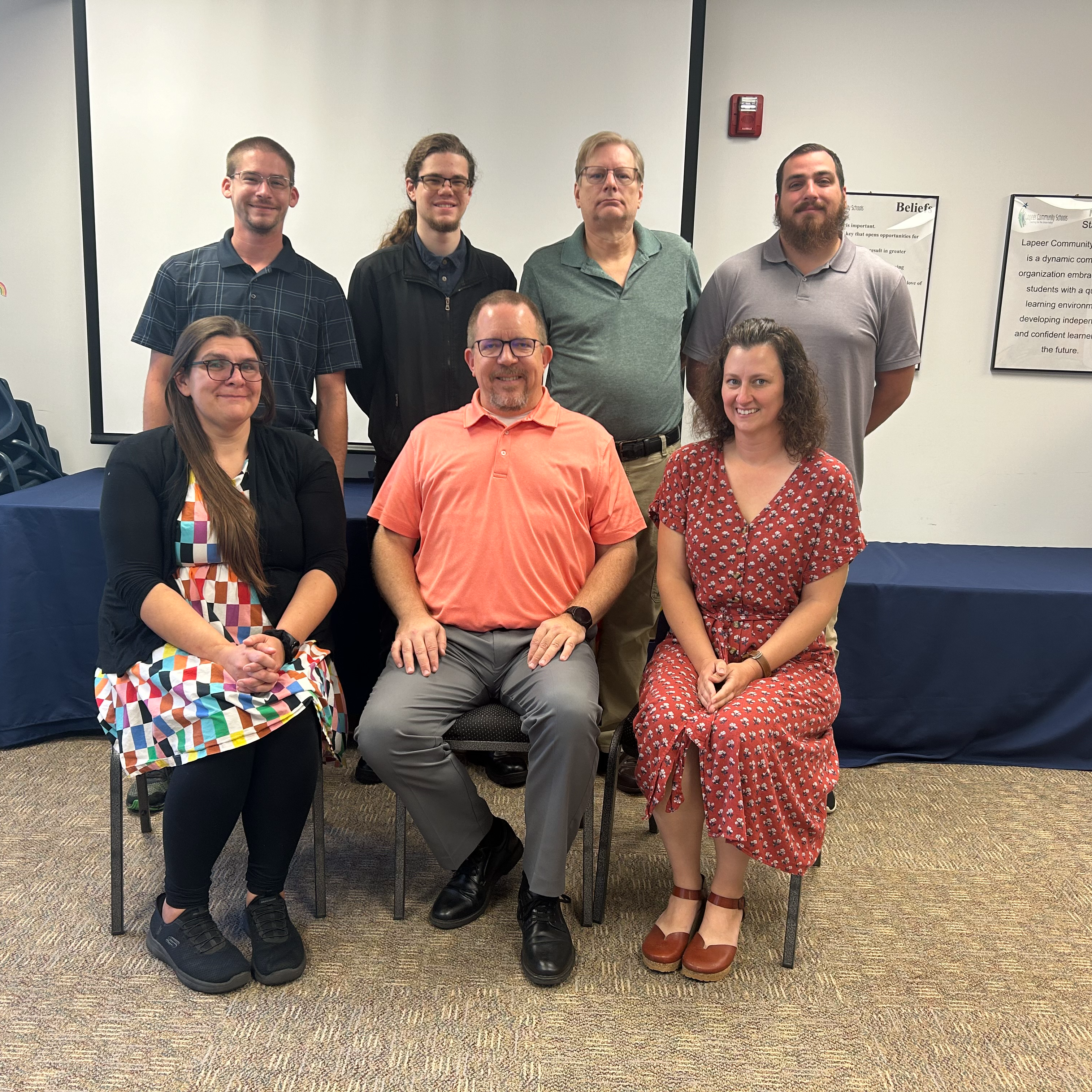 Lapeer Community Schools technology team members - four makes standing, two females and a male seated