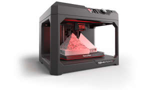 A 3d printer with a red light coming out of it