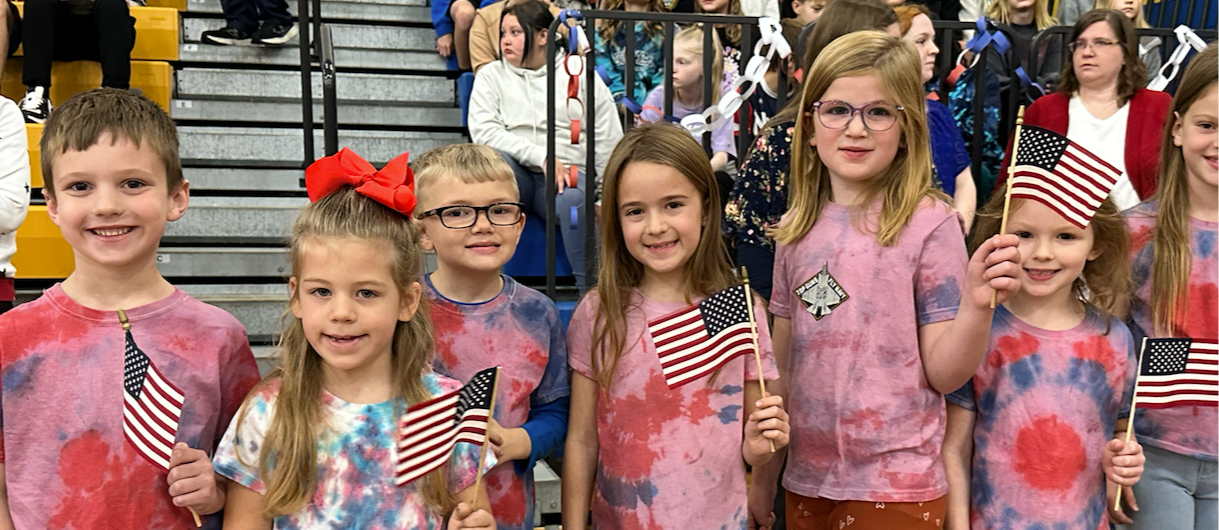 Students standing with mini flags