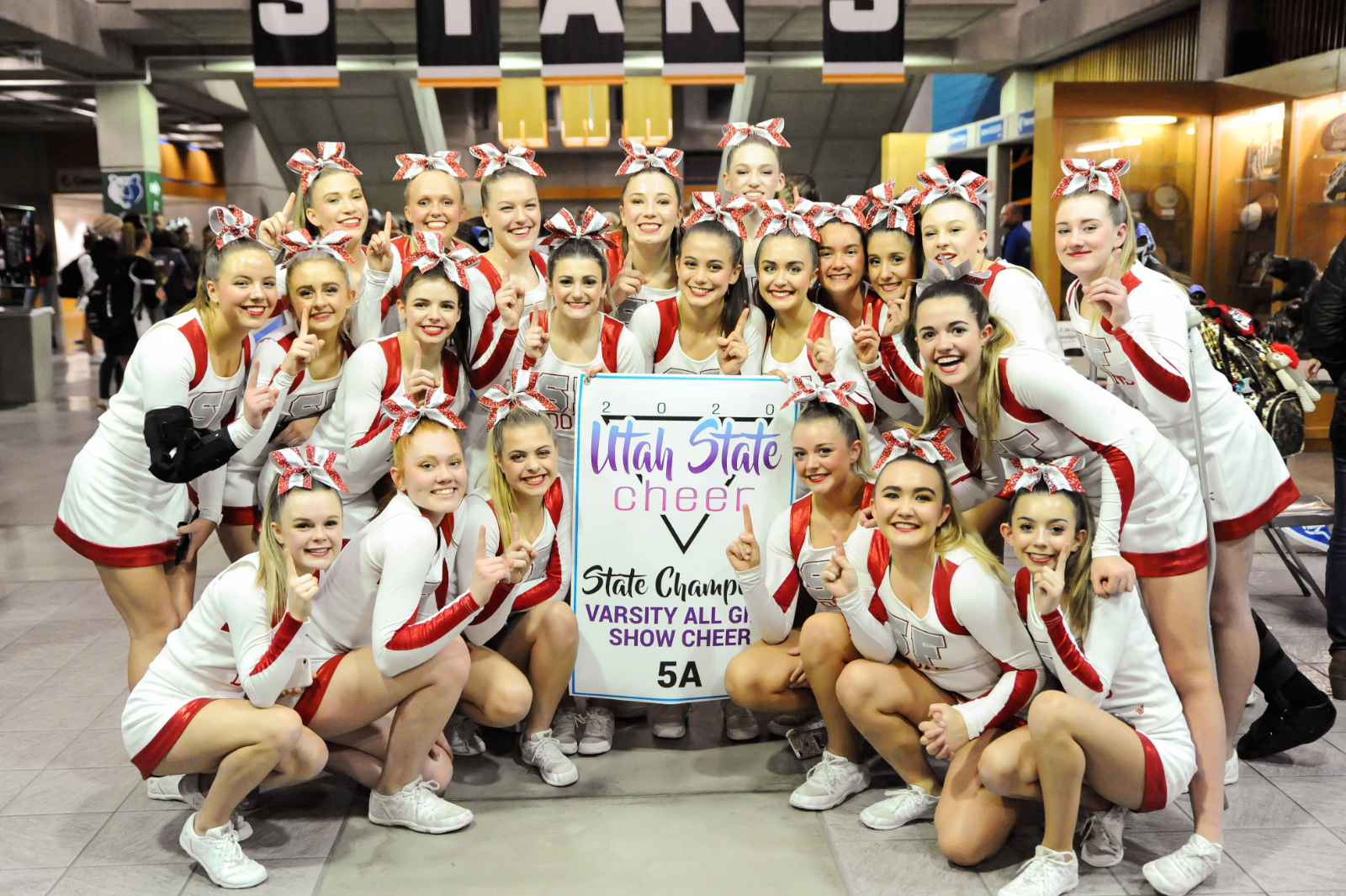 cheerleaders team with a sign