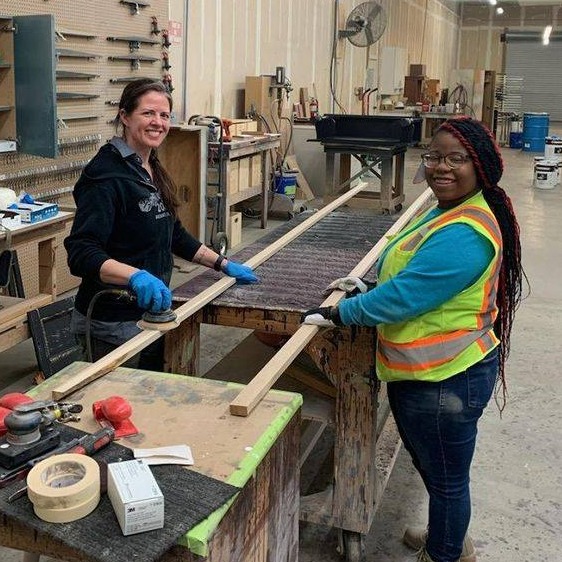 Image shows high school student receiving on the job training in construction.