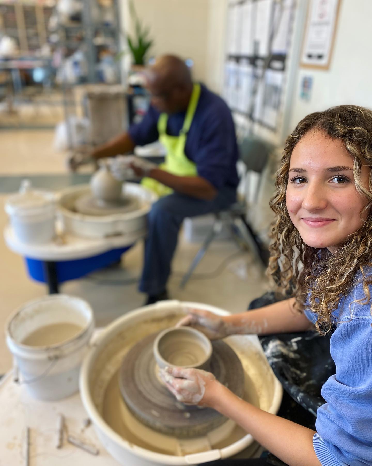 High School student working in pottery class