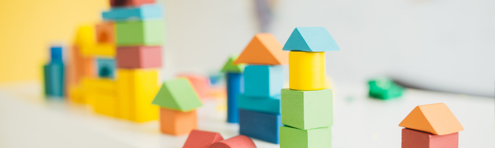 Colorful blocks stacked to look like houses.