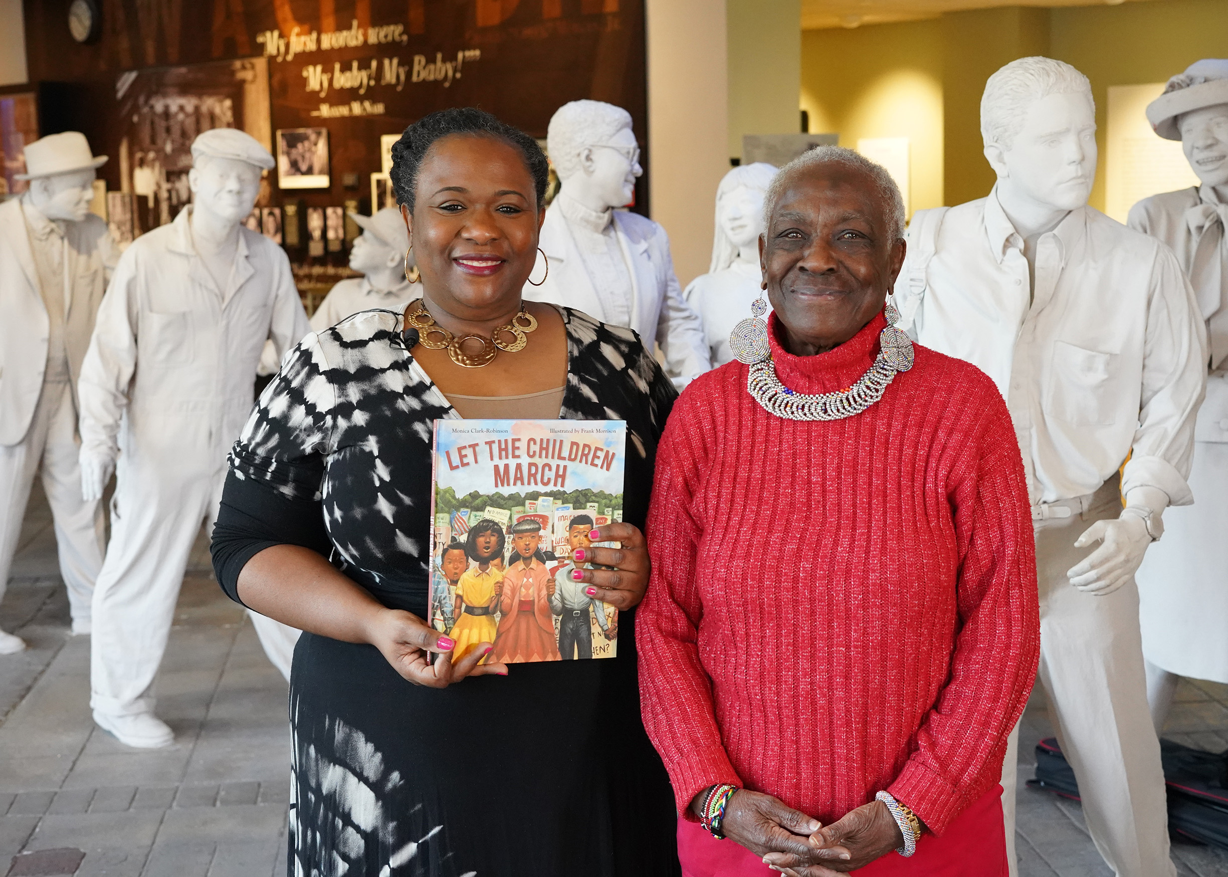 Valyndra Owens and her mother hold the book "Let the Children March" at the Birmingham Civil Rights Institute