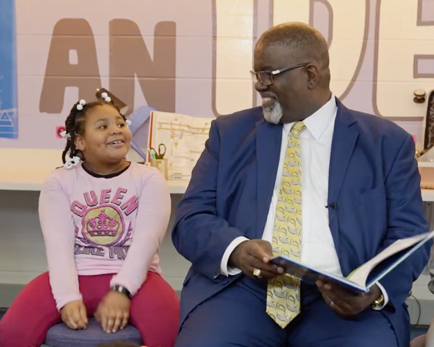 Jay Gary, Area Director for Jefferson County Schools, reads a book to a student at Adamsville Elementary School